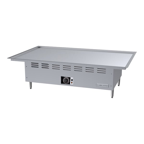 A large stainless steel electric drop-in teppanyaki griddle with a flat cooking surface and control panel.