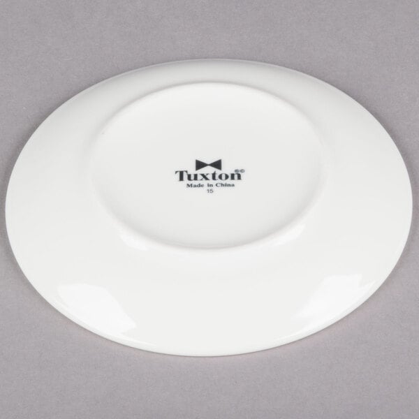 A Tuxton Venice ivory china coupe plate with black text on it.