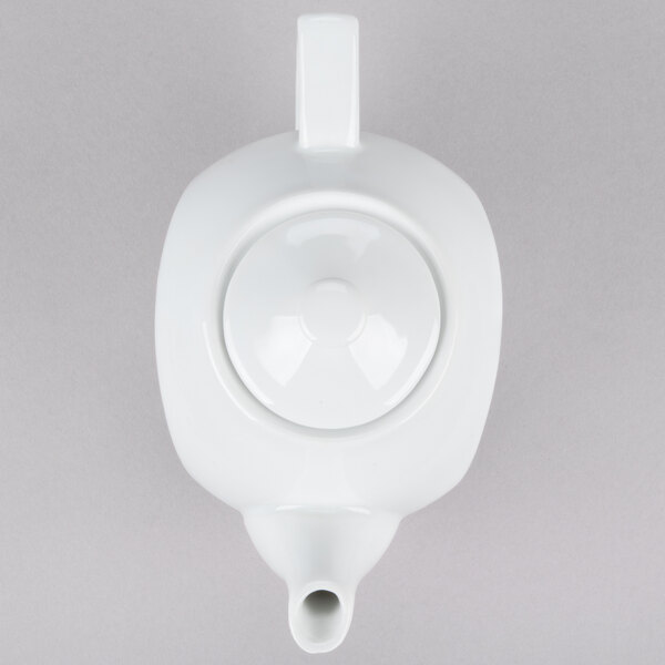 A white CAC porcelain teapot with a lid.