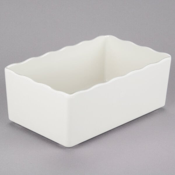 a white rectangular object with scalloped edges