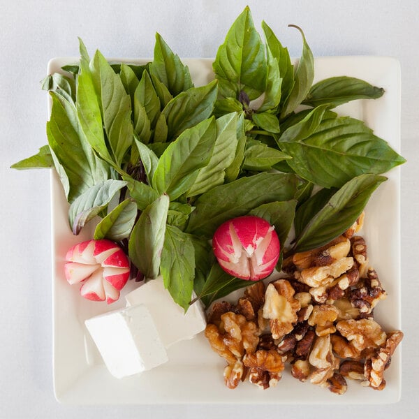 A 10 Strawberry Street Whittier Elite white porcelain square dessert plate with food on it.