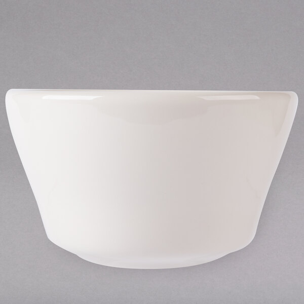 A close-up of a Tuxton Reno eggshell white china bouillon cup.