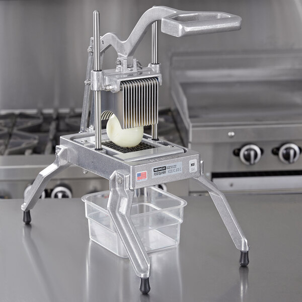 A Nemco Easy Onion / Fruit / Vegetable Slicer II cutting a piece of food.
