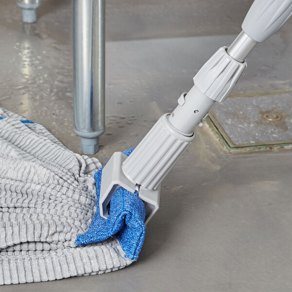 A Unger SmartColor gray jaw string mop holder with a blue cloth on it.