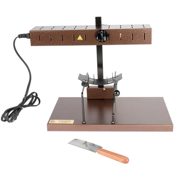 A wooden-handled knife next to a brown cheese wheel.