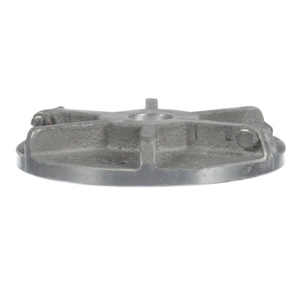 A metal heat slinger with a hole in the middle and a screw.