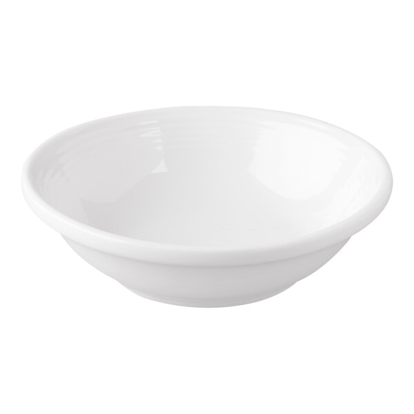 A white porcelain fruit bowl with a curved edge.