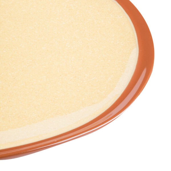 A close up of a Libbey Terracotta plate with a brown rim.