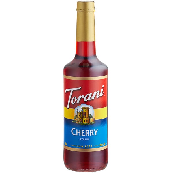 A Torani Cherry Fruit Syrup bottle on a table with a label.