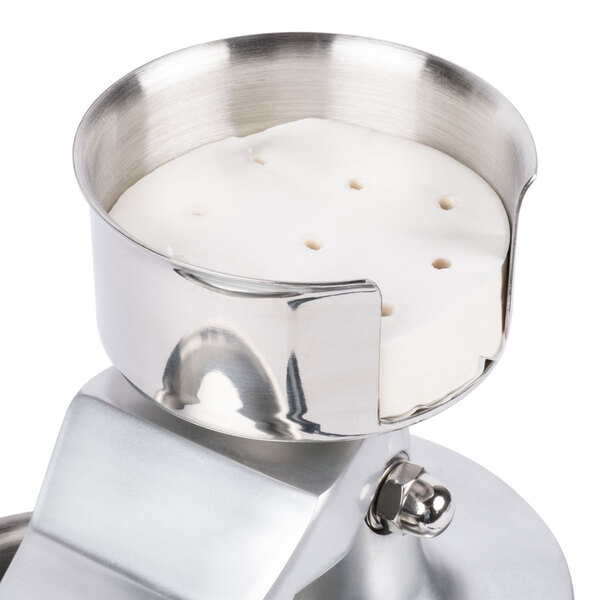 A metal container with round white perforated patty papers inside.