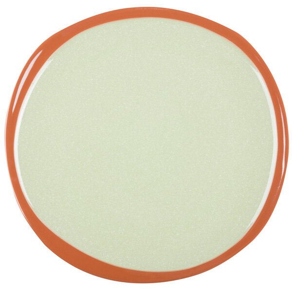 A white stoneware plate with an orange rim.