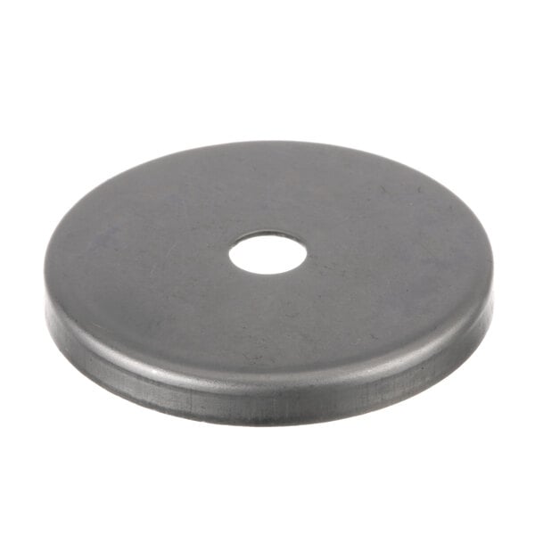 A round black metal disc with a hole in the center.