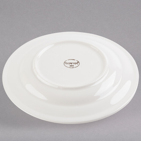 A white Libbey porcelain plate with brown writing on it.
