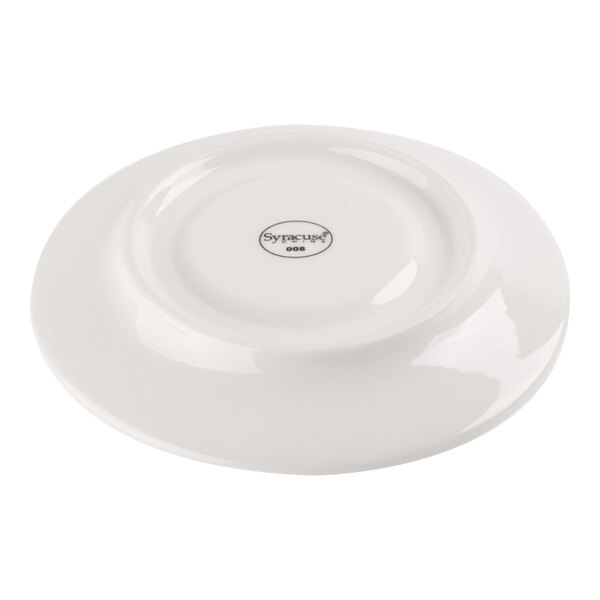 A white porcelain saucer shown upside down with a circular logo and text at the center.