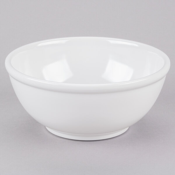 A white Cal-Mil melamine bowl on a gray surface.