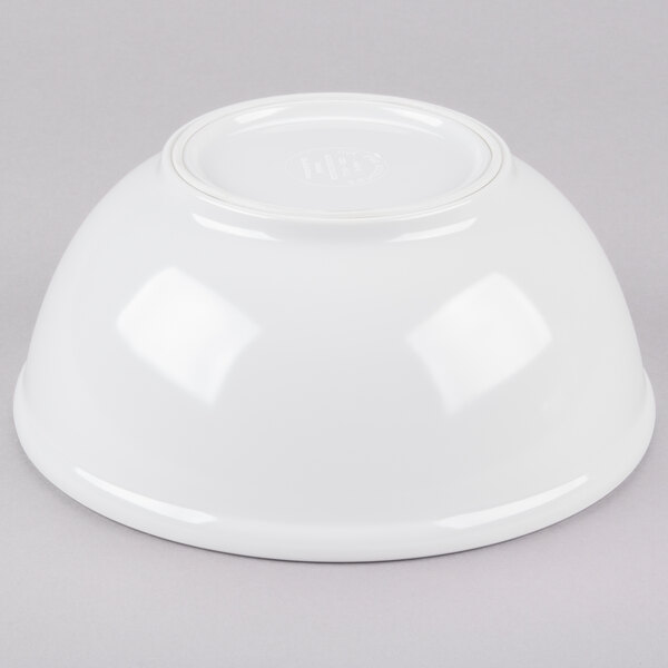 A white Cal-Mil round melamine bowl on a gray background.