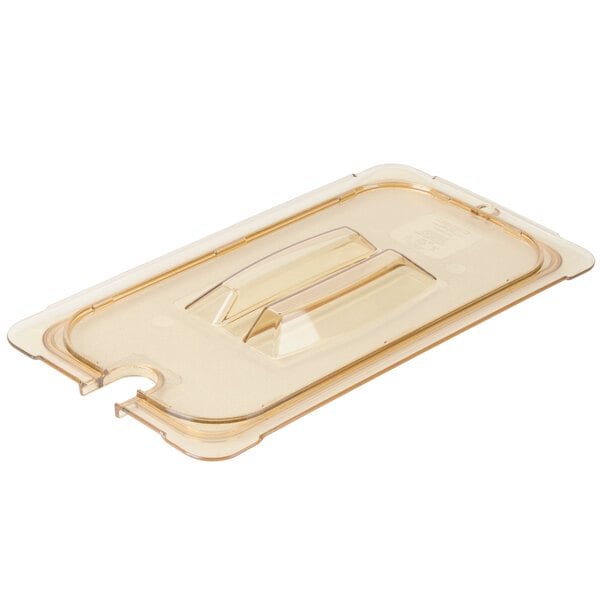 A clear plastic Carlisle 1/3 size food pan lid with a handle and spoon notch.