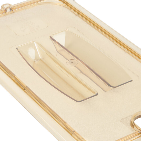 A clear plastic container with a round lid and a spoon notch.