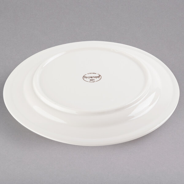 a white plate with a brown logo