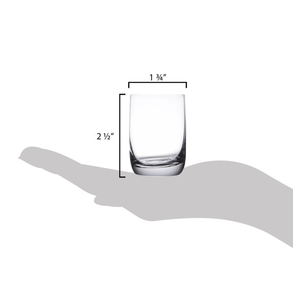 A hand holding a Stolzle Weinland shot glass with measurements.