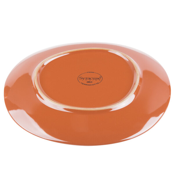 A Libbey terracotta plate in fern green on a table.