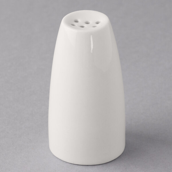 A Libbey ivory porcelain salt shaker on a gray surface.