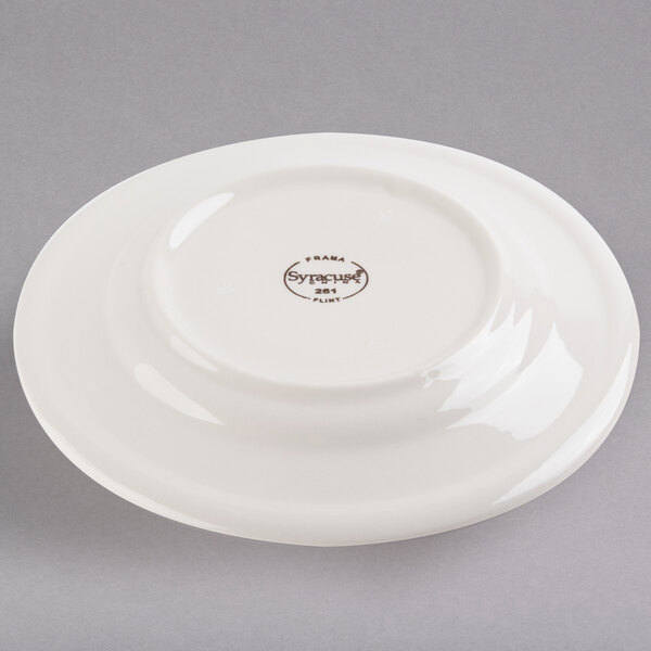 A Libbey ivory porcelain plate with brown writing on it.