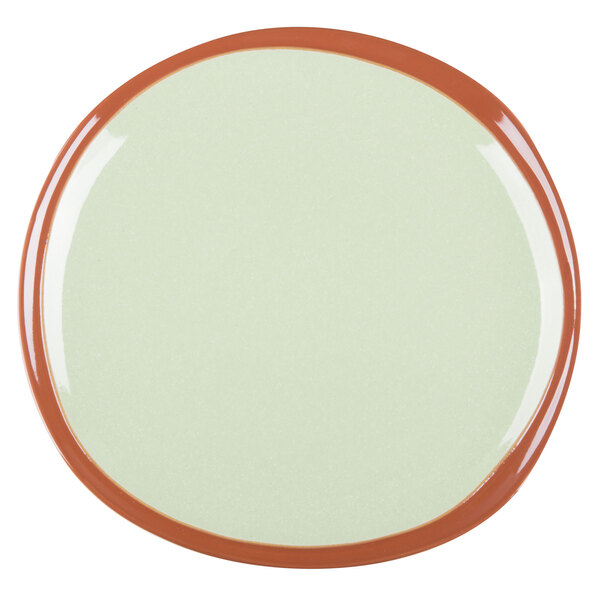 A close-up of a Libbey terracotta plate with a fern green rim and orange center.
