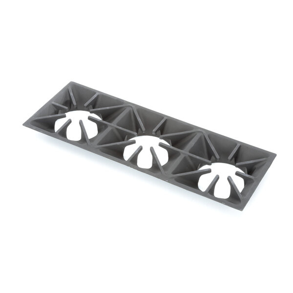 A grey plastic Southbend grate top with white holes.