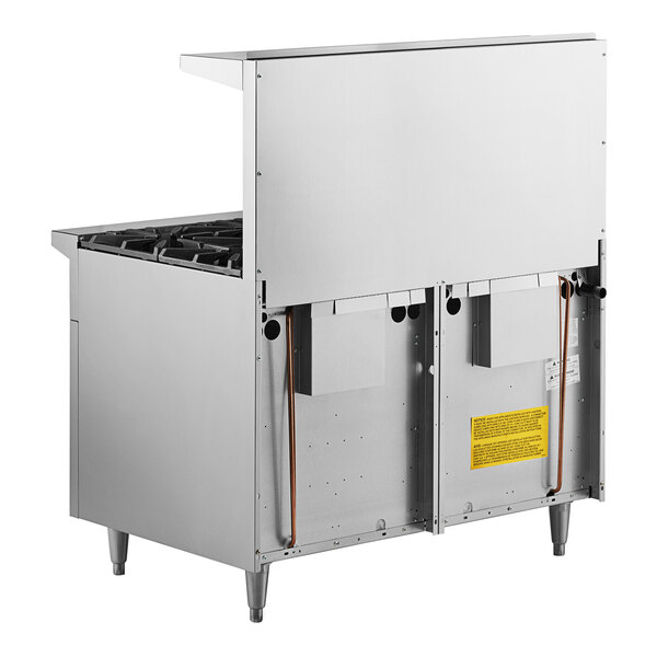 A large stainless steel Garland commercial gas range with two space saver ovens.