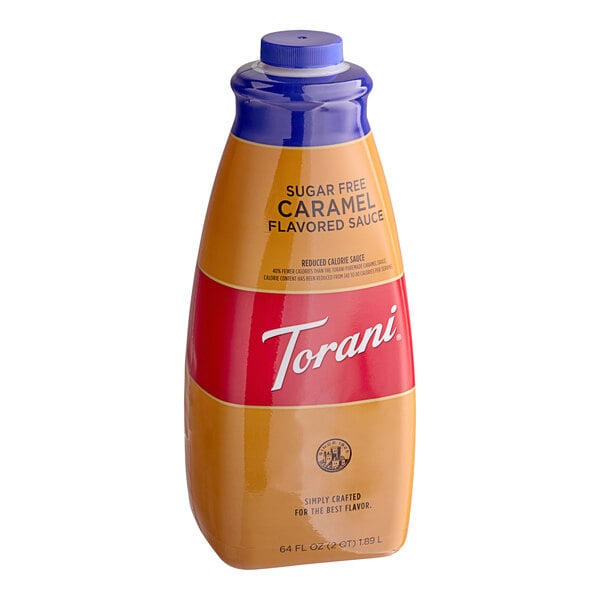 A close-up of a Torani Sugar-Free Caramel Flavoring Sauce bottle with a blue lid.