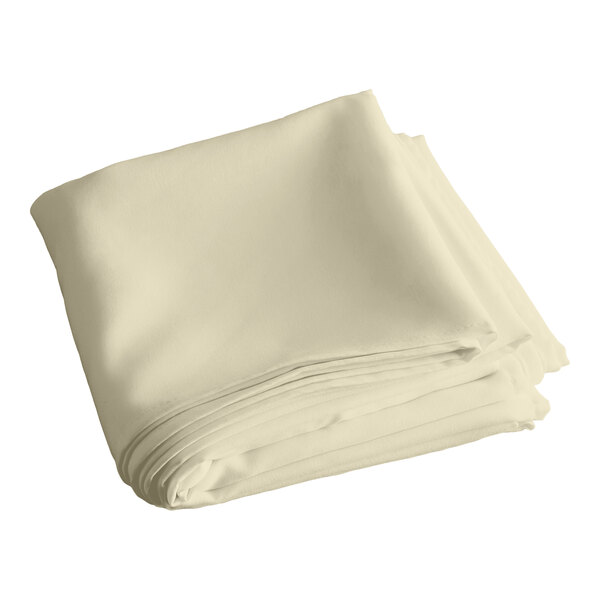 A stack of folded ivory square table covers.