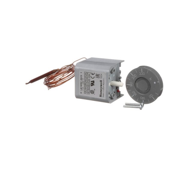 A small grey circular Lochinvar high limit switch with a wire.
