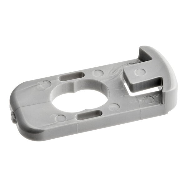 A grey plastic piece with a hole in the middle.