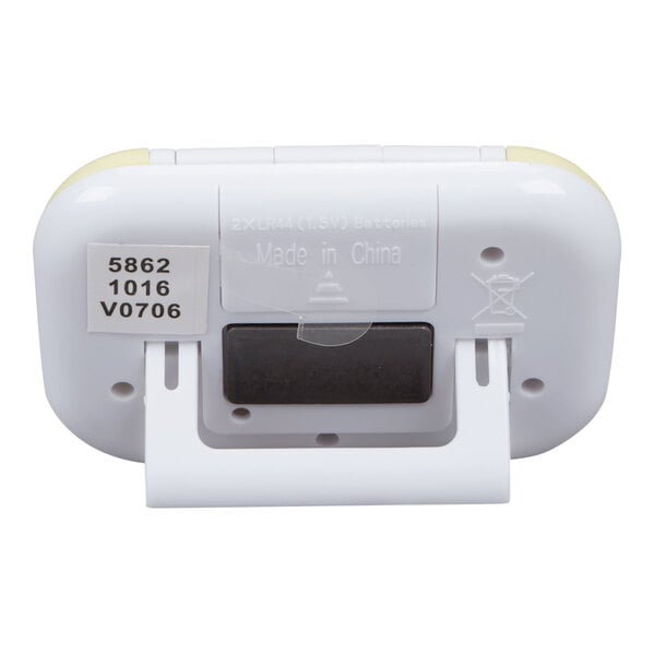 A white digital kitchen timer with a fold-out stand and a label displaying model information on the back.