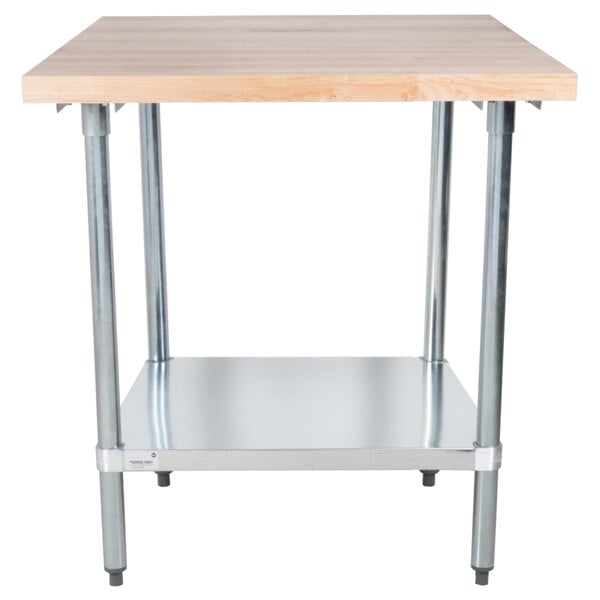 An Advance Tabco wood top work table with a galvanized metal base and undershelf.