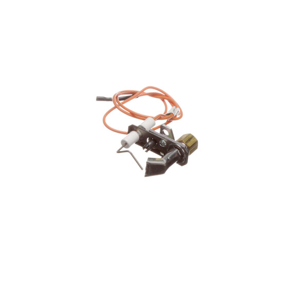 A close-up of a US Range spark ignition pilot with an orange cable.