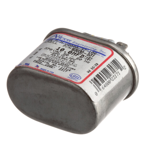 A small metal Jade Range capacitor with a label.