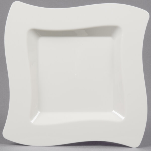 A white square Fineline plastic plate with a curved edge.