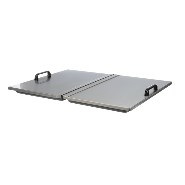 A stainless steel lid with two handles on a table.
