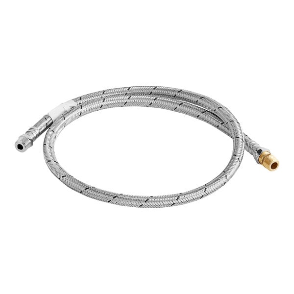 A close-up of a stainless steel flexible hose with a gold connector.