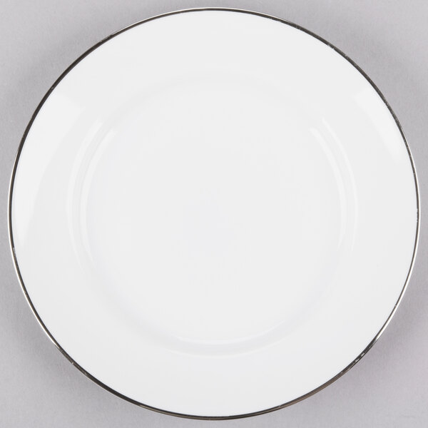 A white porcelain bread and butter plate with a silver rim.