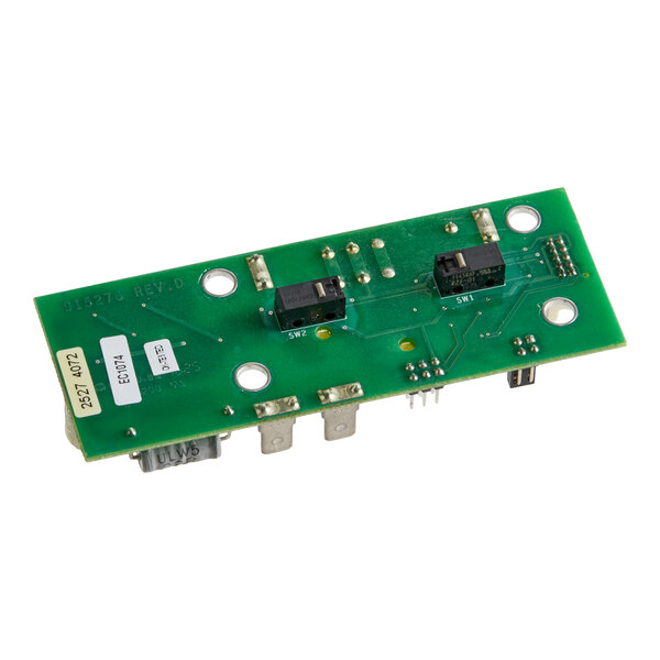 A green printed circuit board with various electronic components, including switches and connectors, mounted on it.