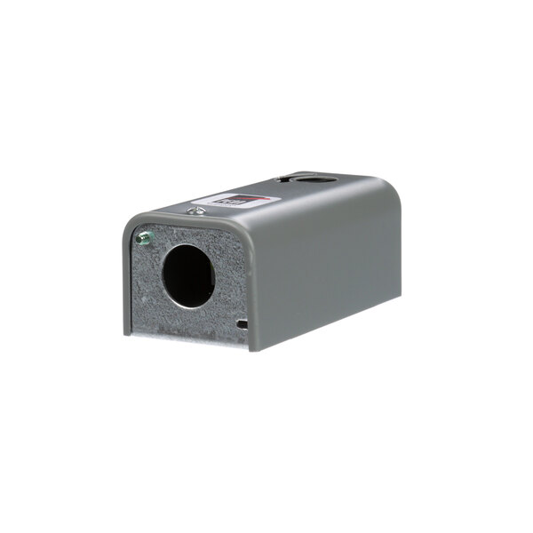 A close-up of a grey rectangular Norlake cold control with a hole in it.