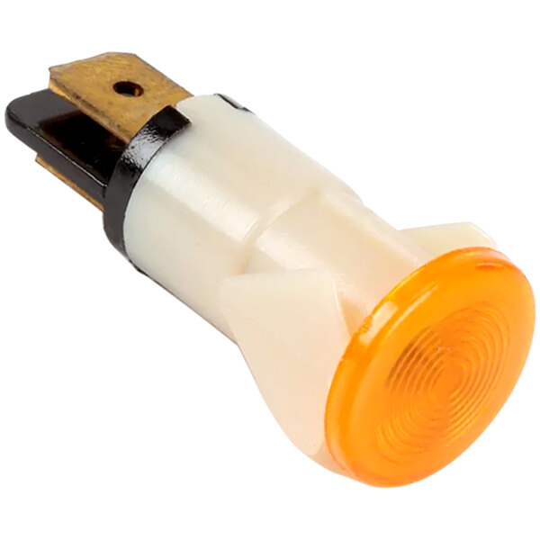 A close-up of a yellow indicator light on a metal object.