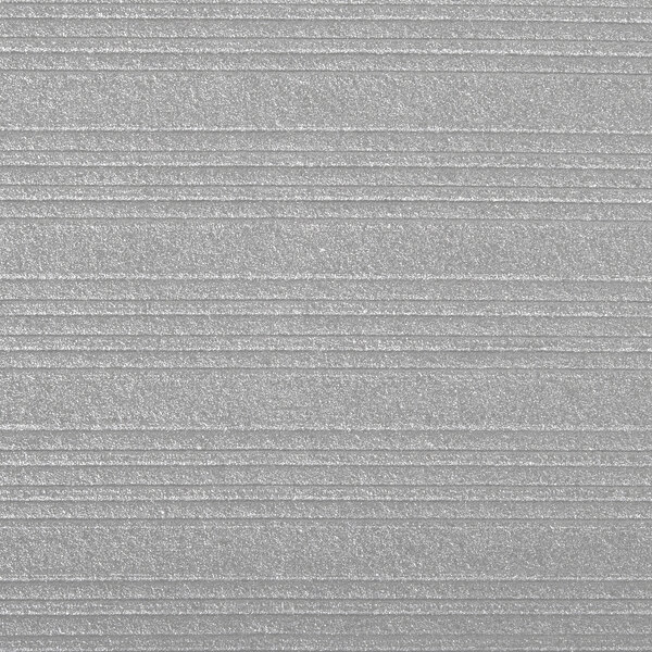 A close-up of a grey surface with a ribbed texture.
