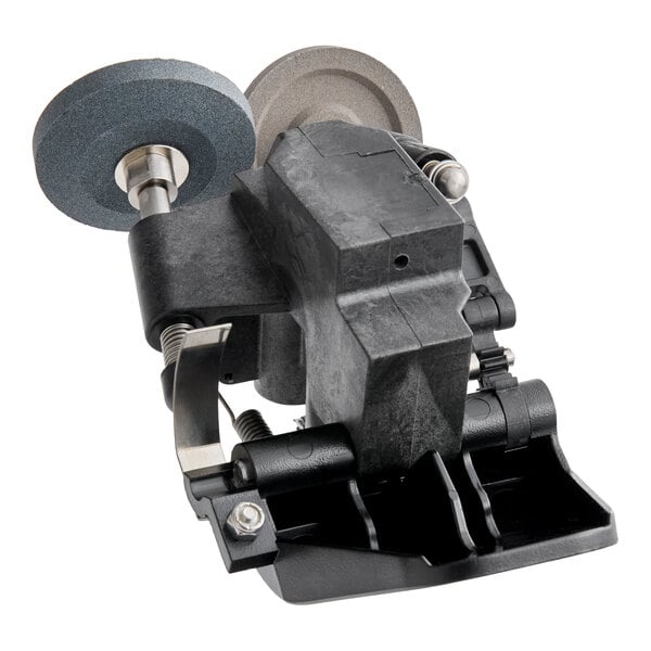A mechanical sharpening assembly with two grinding wheels and a black plastic housing, viewed from an angle.