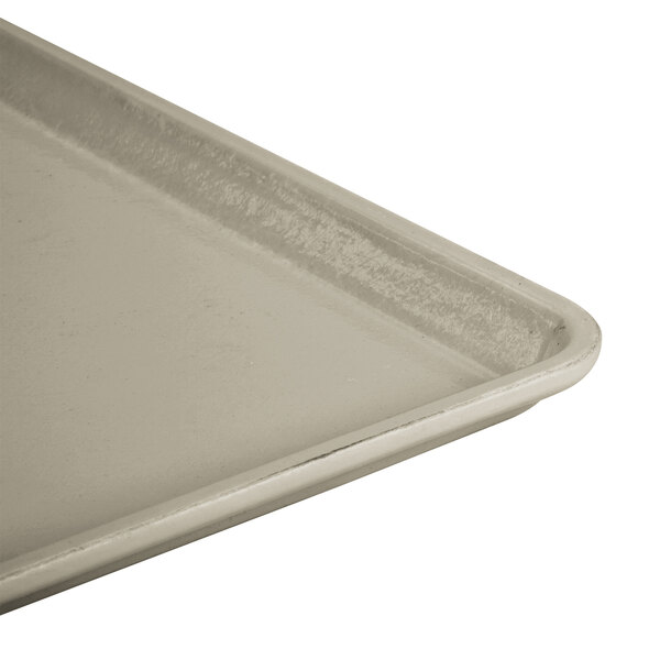 A close-up of a Cambro desert tan dietary tray.