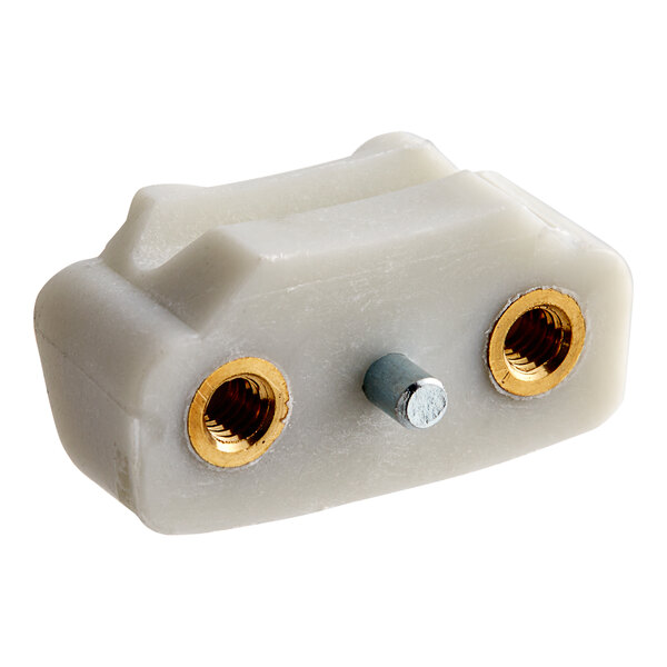 A white plastic Hobart shoe connector with gold screws.