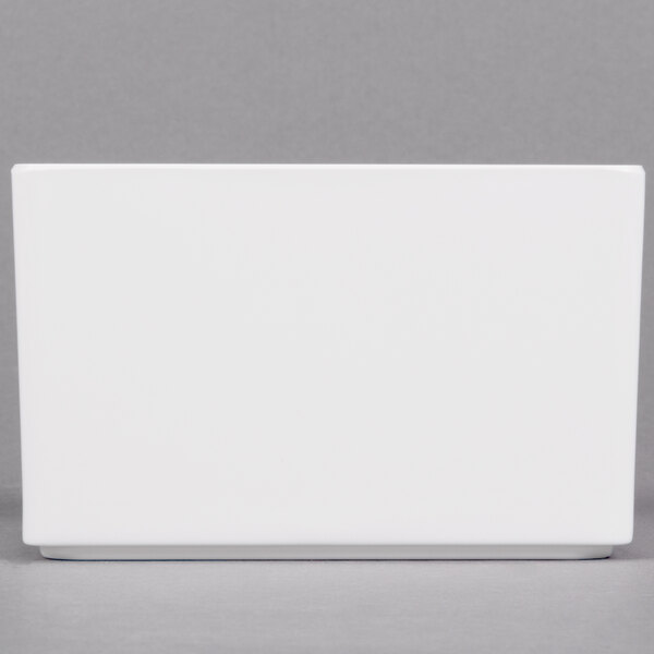 A white rectangular box with a gray border on a gray surface.